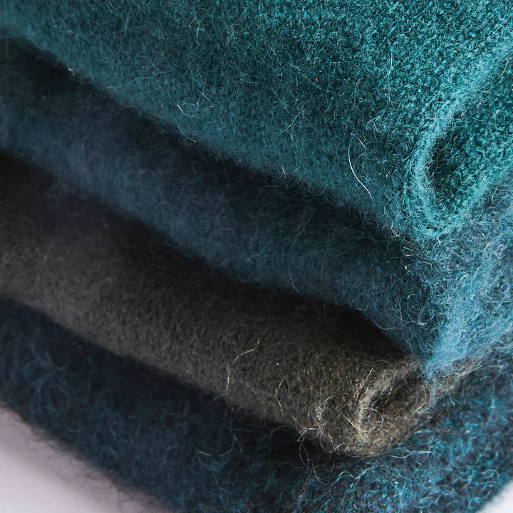 Close up of tones of woodlands green recycled cashmere glove folded