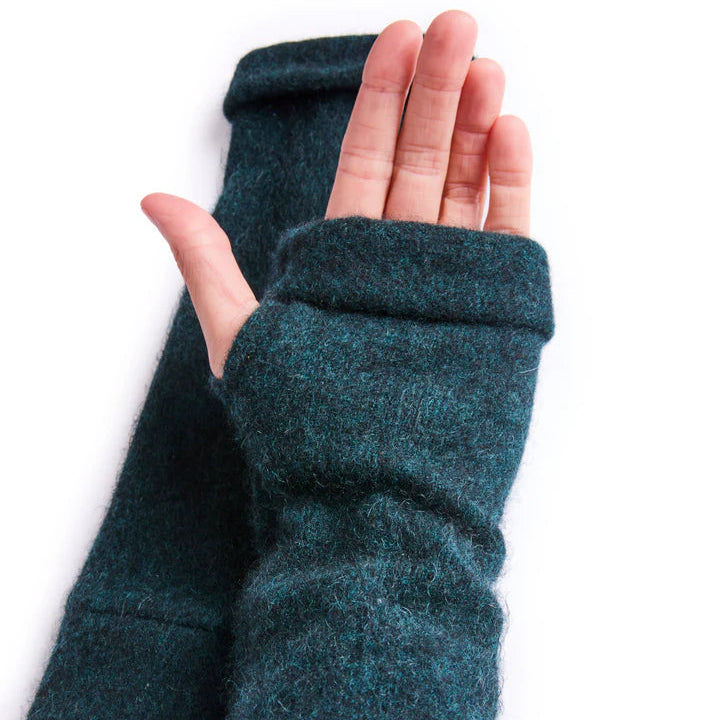 Close up of palm of hand wearing recycled cashmere glove in green on white surface