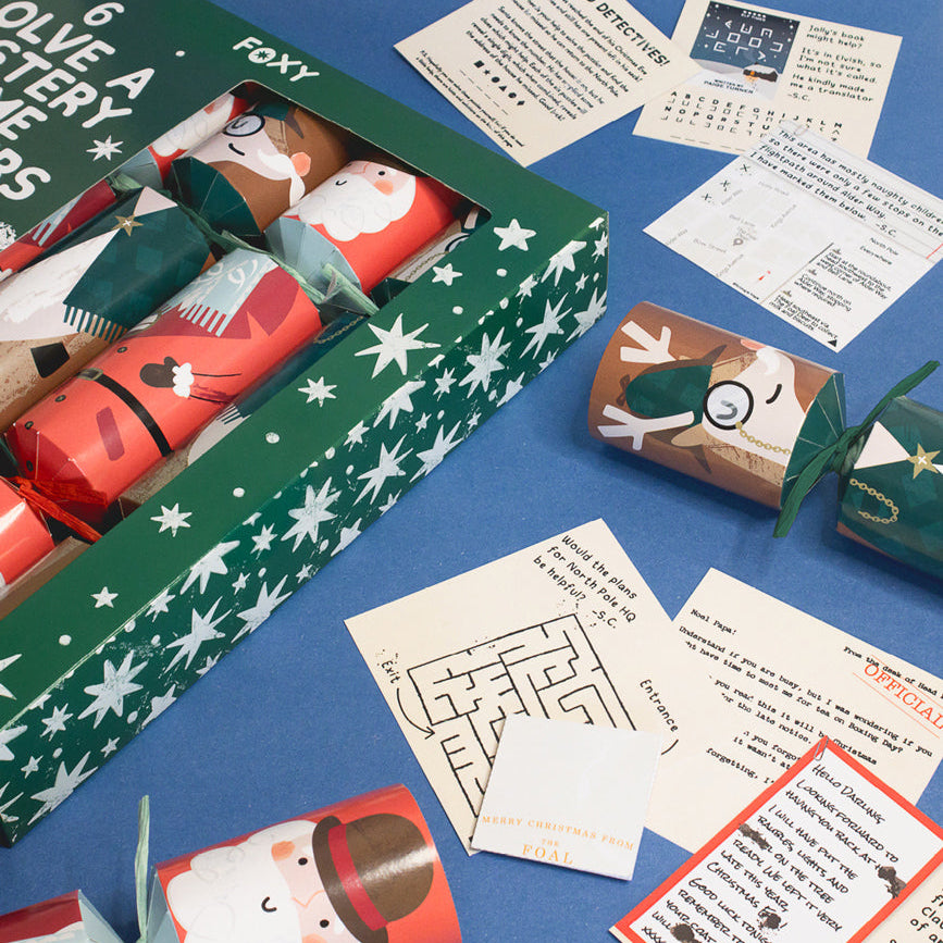 Solve a mystery game crackers pack and ingredients of mystery cards laid on blue surface