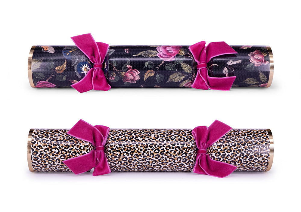 2 designs of cracker, jaguar pint and floral and moth print on cardboard on white surface