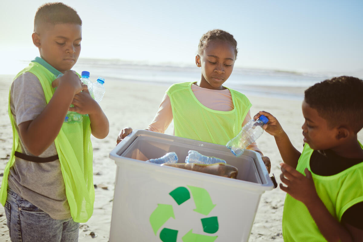Children working together to pick up litter for recycling