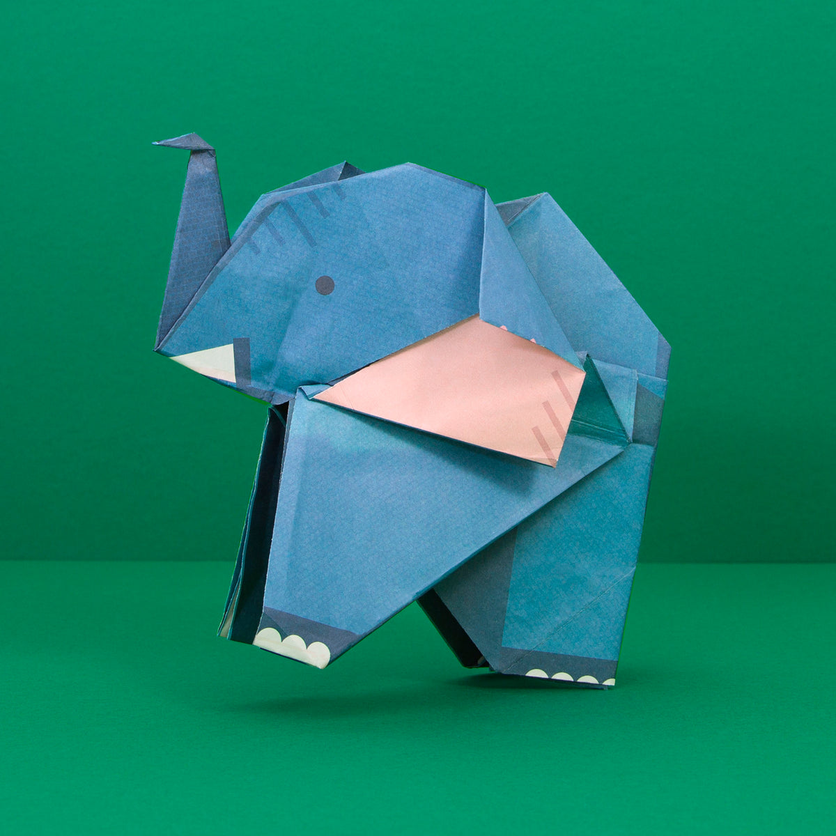 Origami Elephant constructed on green background
