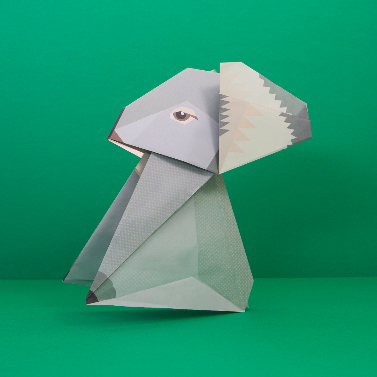 Origami Koala constructed on green background