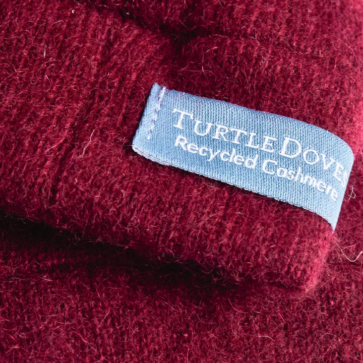 Close up of Turtle doves sewn in label on glove stating recycled cashmere