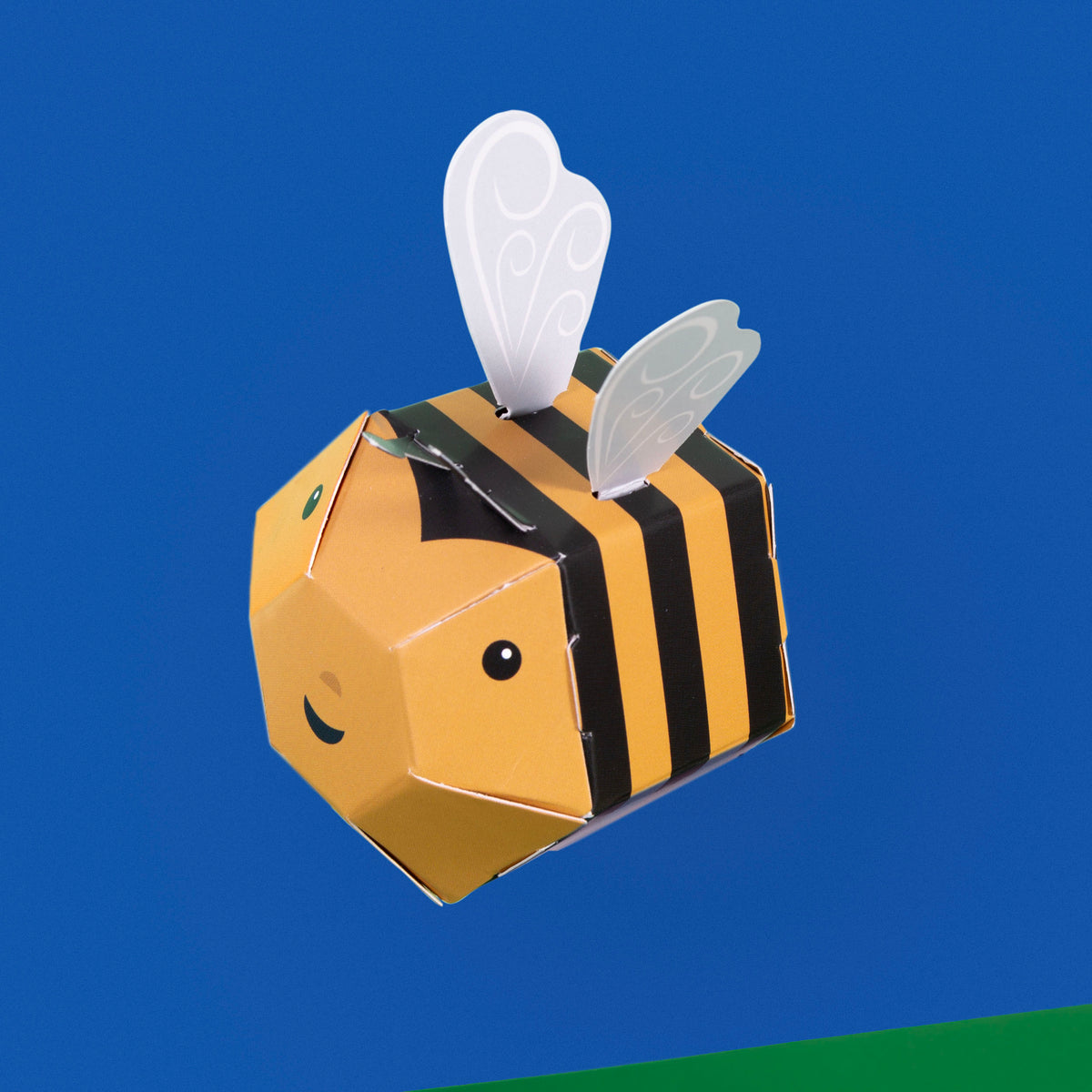 Cardboard kit bee on blue background