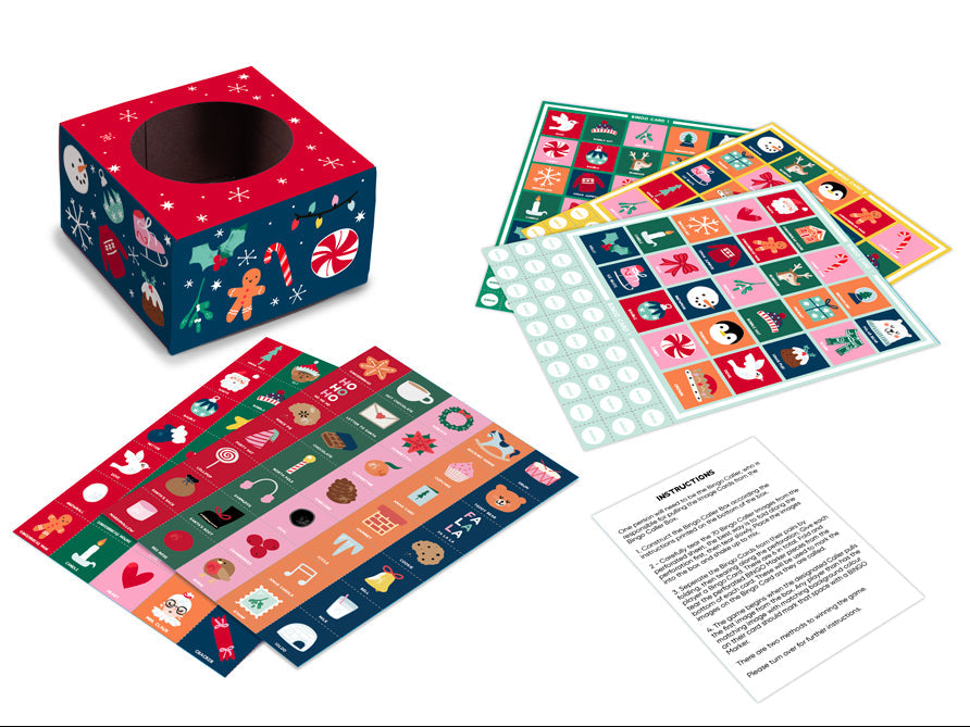 Christmas illustrated Bingo game made from card on box, boards and counters laid on a white surface with instructions