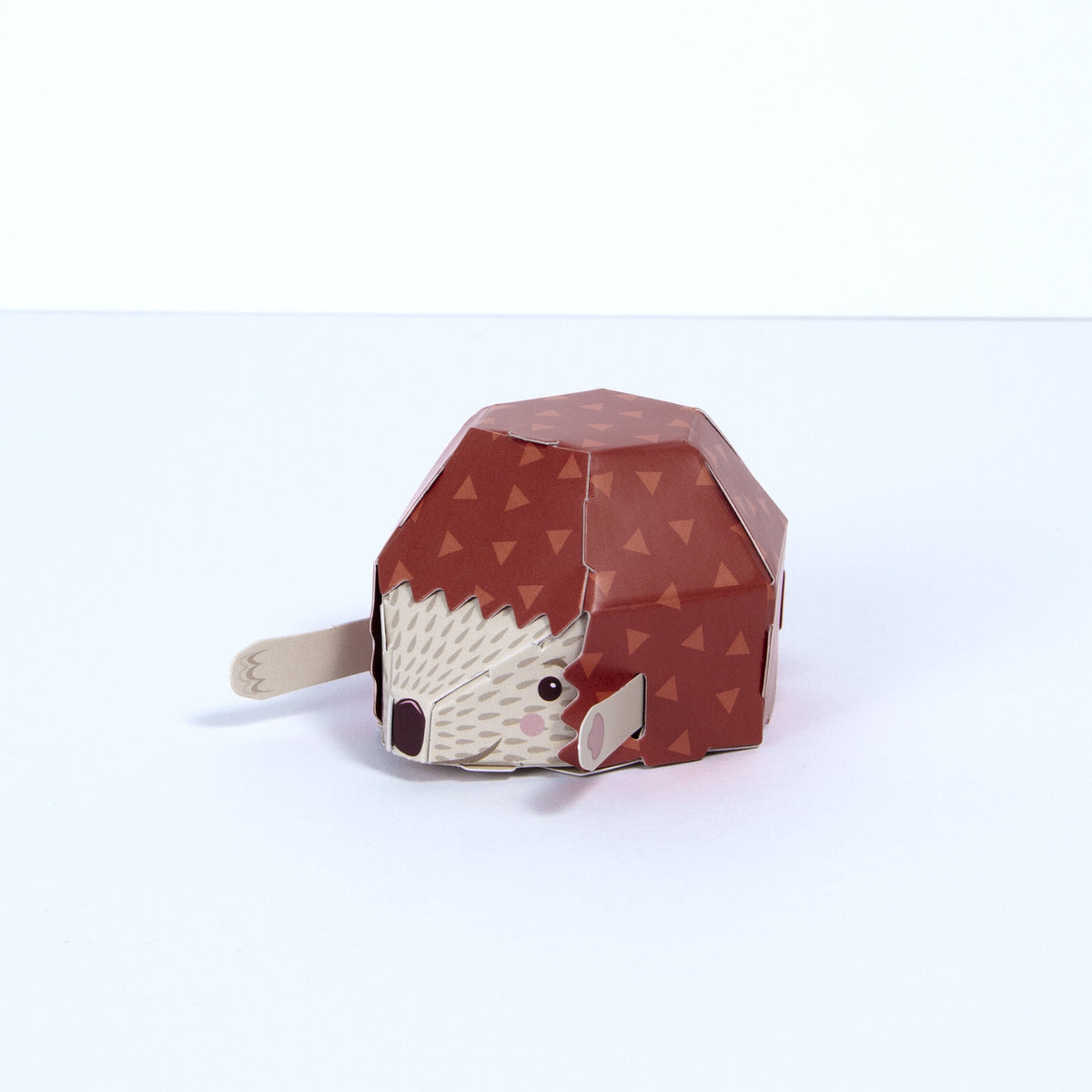 Fully assembled cardboard hedgehog from above angle on white background