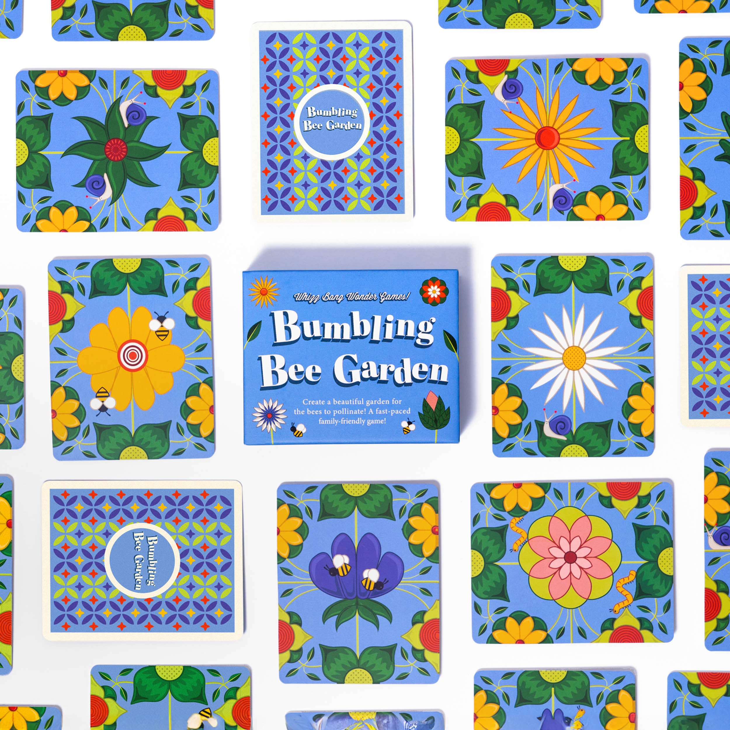Bumbling Bee Garden Game box with floral cards laying next to it on white background