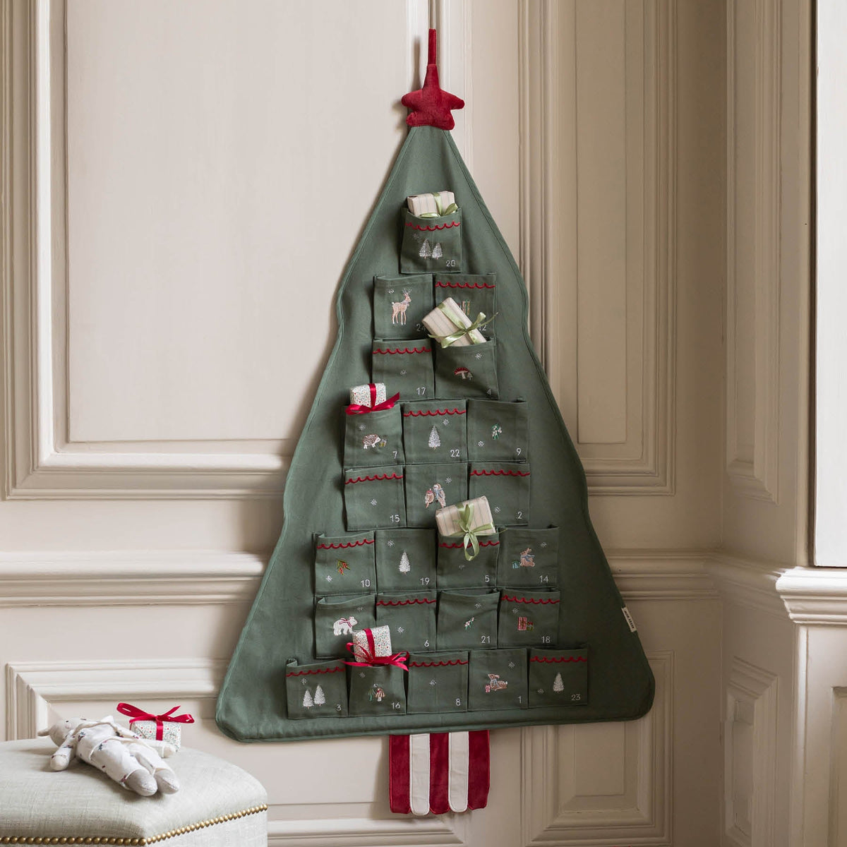 Cotton green Christmas tree reusable advent calendar hanging on wall with presents in pockets 