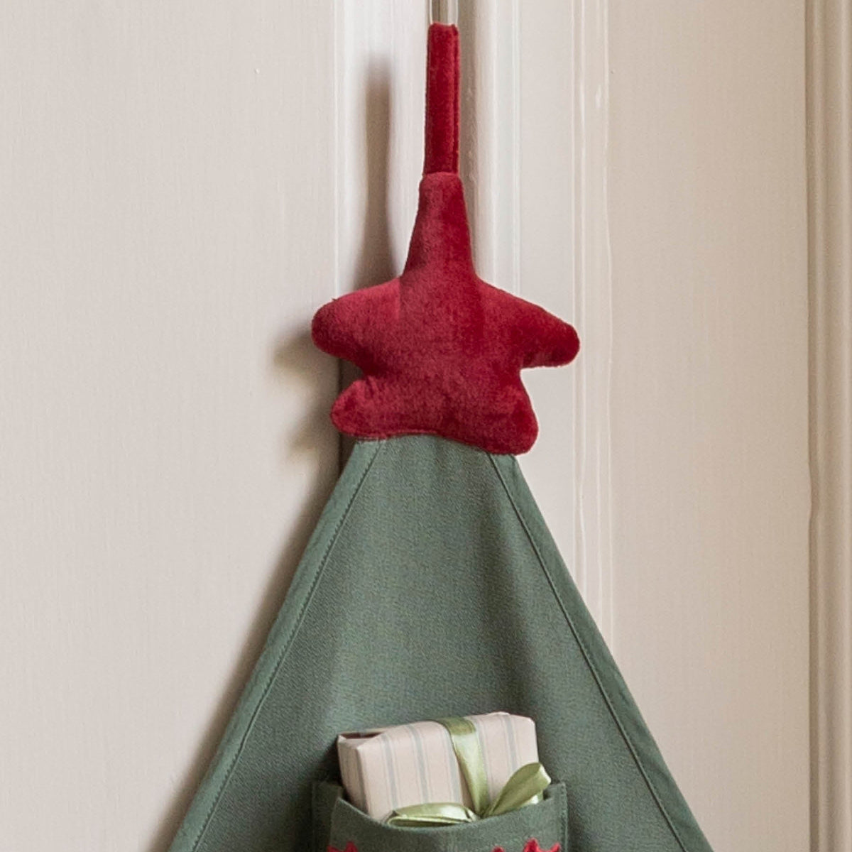 Close up of top of Advent with cotton red velvet star and hanging tie.