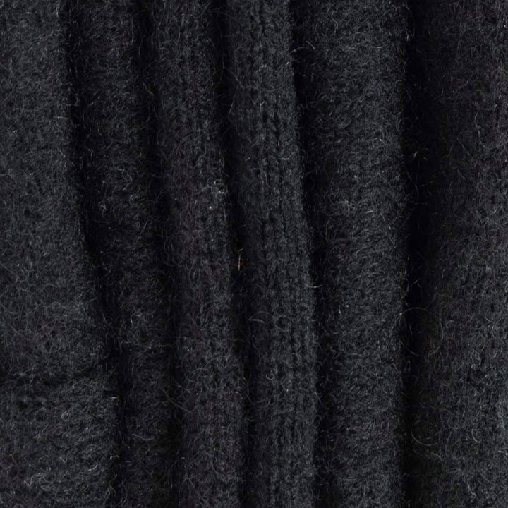Close up of recycled cashmere neck warmers folded in tones of black