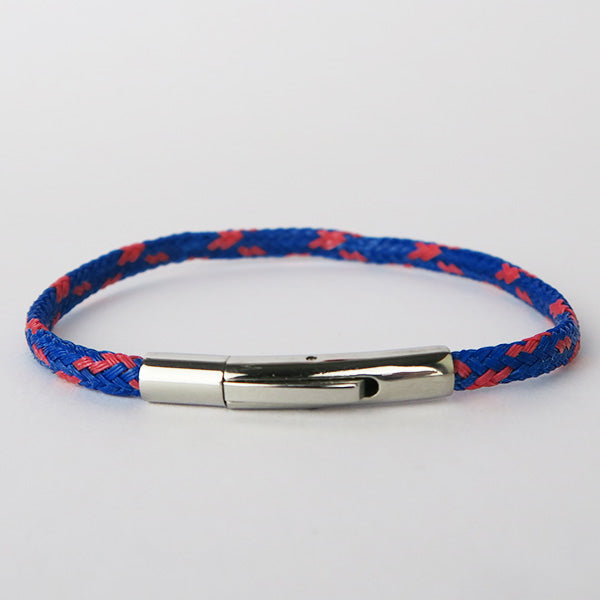 Close up of Blue and Red recycled fishing net bracelet with silver clasp on white surface