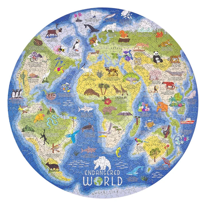 Flay lay of the completed circular Endangered World Puzzle with illustrated animals from around the world on a map on white background