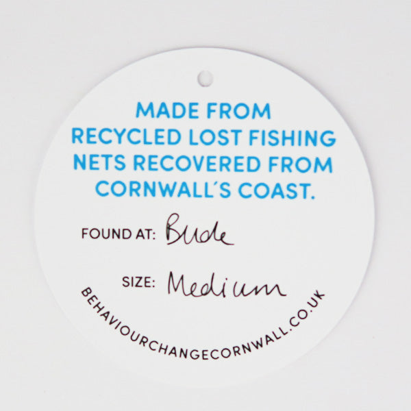 Close up of example of card which comes with bracelet describing the location of the beach the fishing net was found and bracelet size