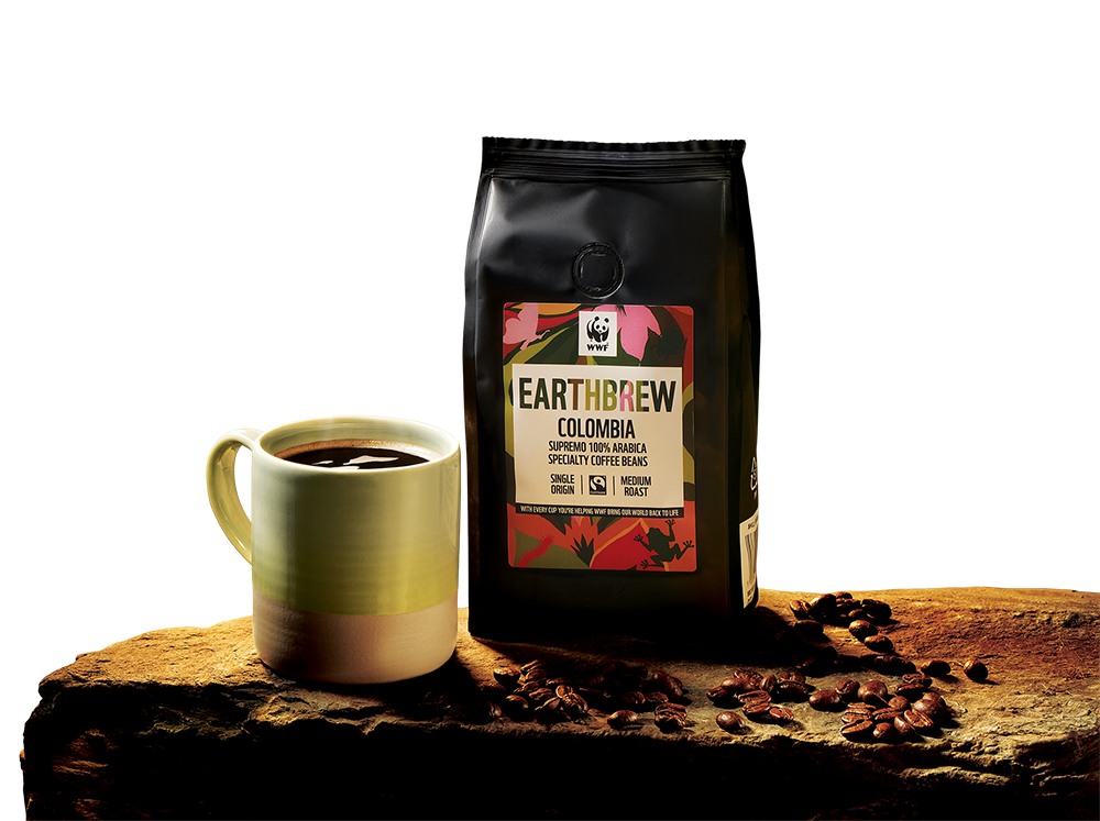 A mug of Earthbrew coffee beside a bag of Earthbrew Colombia beans